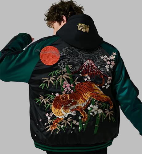 Rear view of model wearing Night of Tiger reversible sukajan jacket from Sukajan Mall.