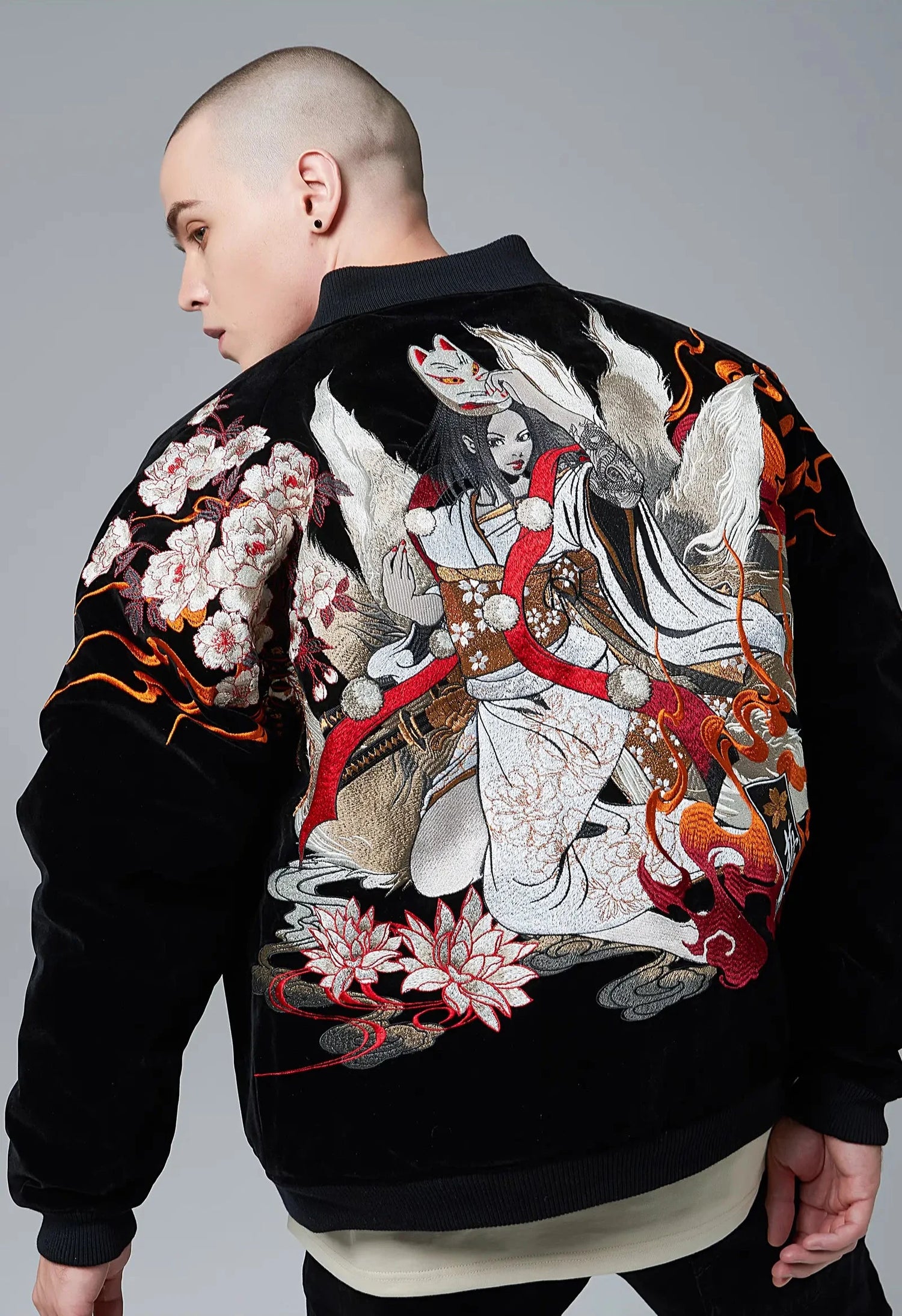 Back view of a model wearing the insulated Nine Tailed Fox sukajan jacket from Sukajan Mall.